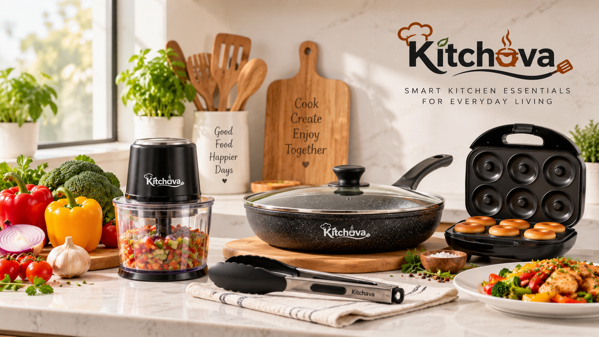A Kitchova smart kitchen essentials set displayed on a marble countertop in a bright kitchen setting, featuring a black food chopper with chopped vegetables, a black frying pan with a glass lid, a black multi-cake pan with golden-brown pastries, and a black spatula, surrounded by fresh produce and cooked food.